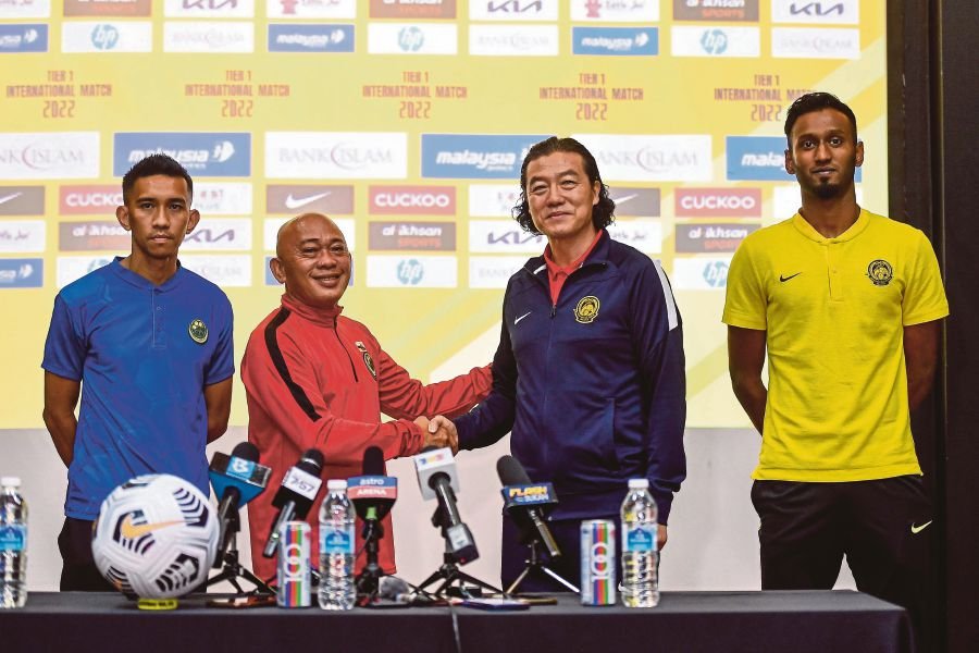 National coach Kim Pan Gon (right) and his Brunei counterpart, Rosanan Samak at a press conference at Wisma FAM in Kelana Jaya yesterday.