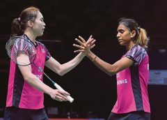 Pearly Tan (left) and M. Thinaah celebrate after beating Thailand’s Jongkolphan Kititharakul and Rawinda Prajongjai in their Uber Cup match on Monday.